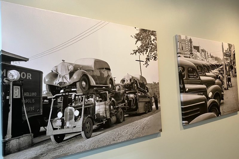 Automotive photographs displayed on a dealership wall