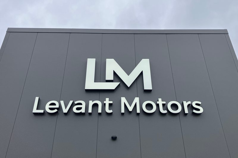 The LM and Levant Motors signs on the building