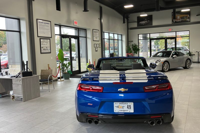 A blue convertible facing into the showroom