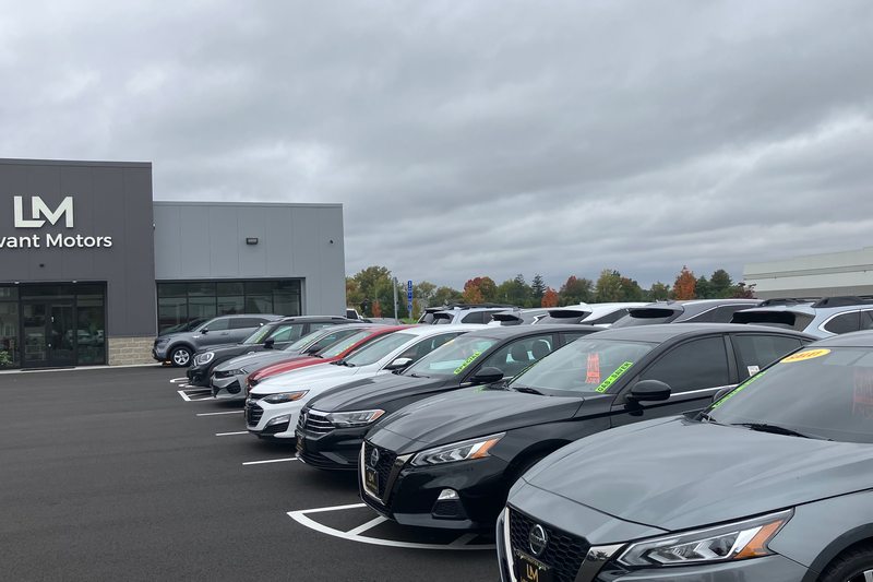 Rows of photographed vehicles outside the dealership