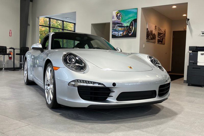 A silver coupe photographed on the Levant Motors showroom floor