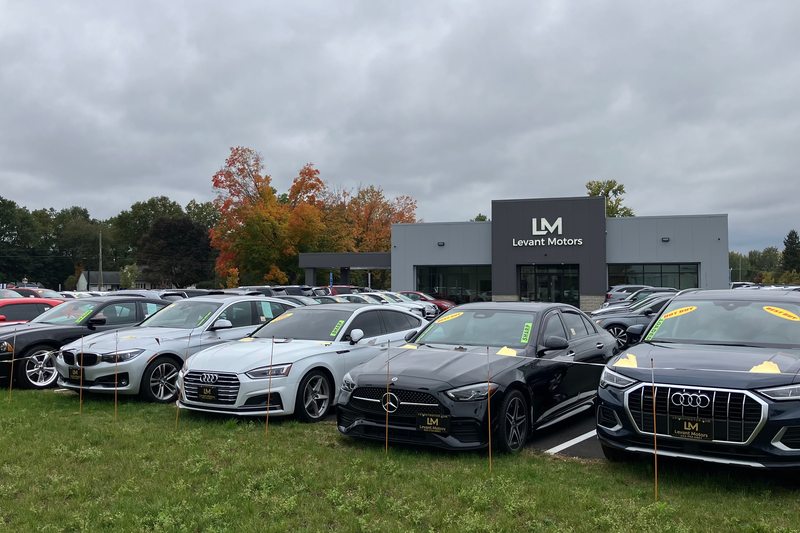 A roadside view of vehicles in front of the showroom
