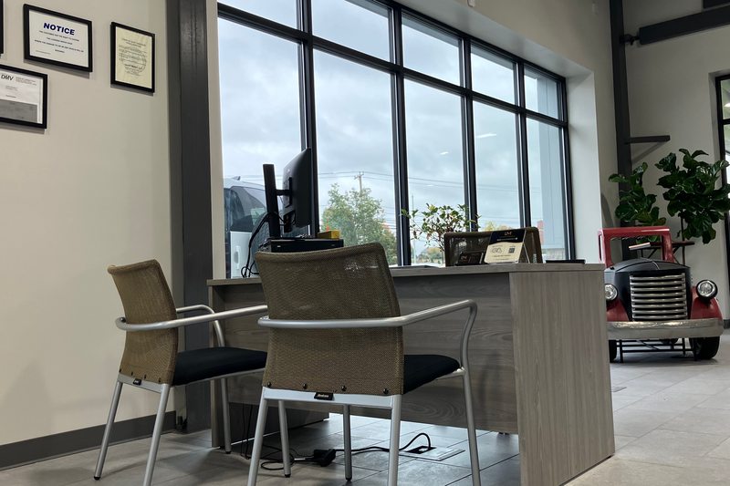 A sales desk beside the tall showroom windows